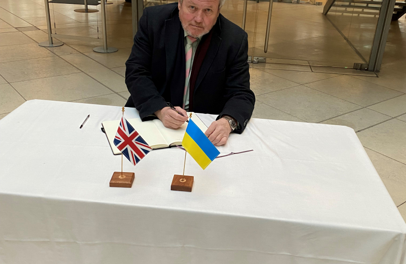 Giles signing the book to Ukraine