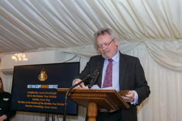 Giles presenting an award